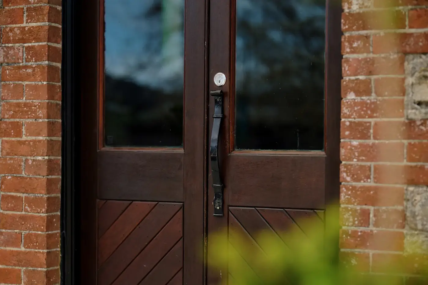 The wrought iron handle on the timber door