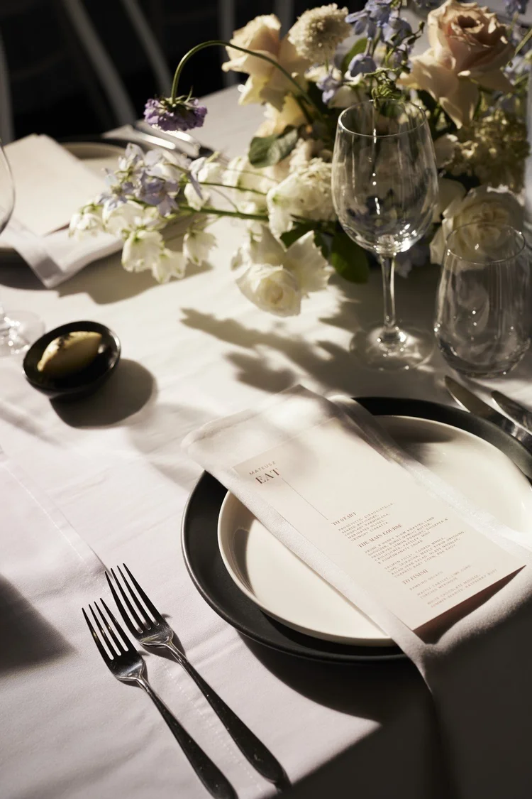A place setting with menu and flowers