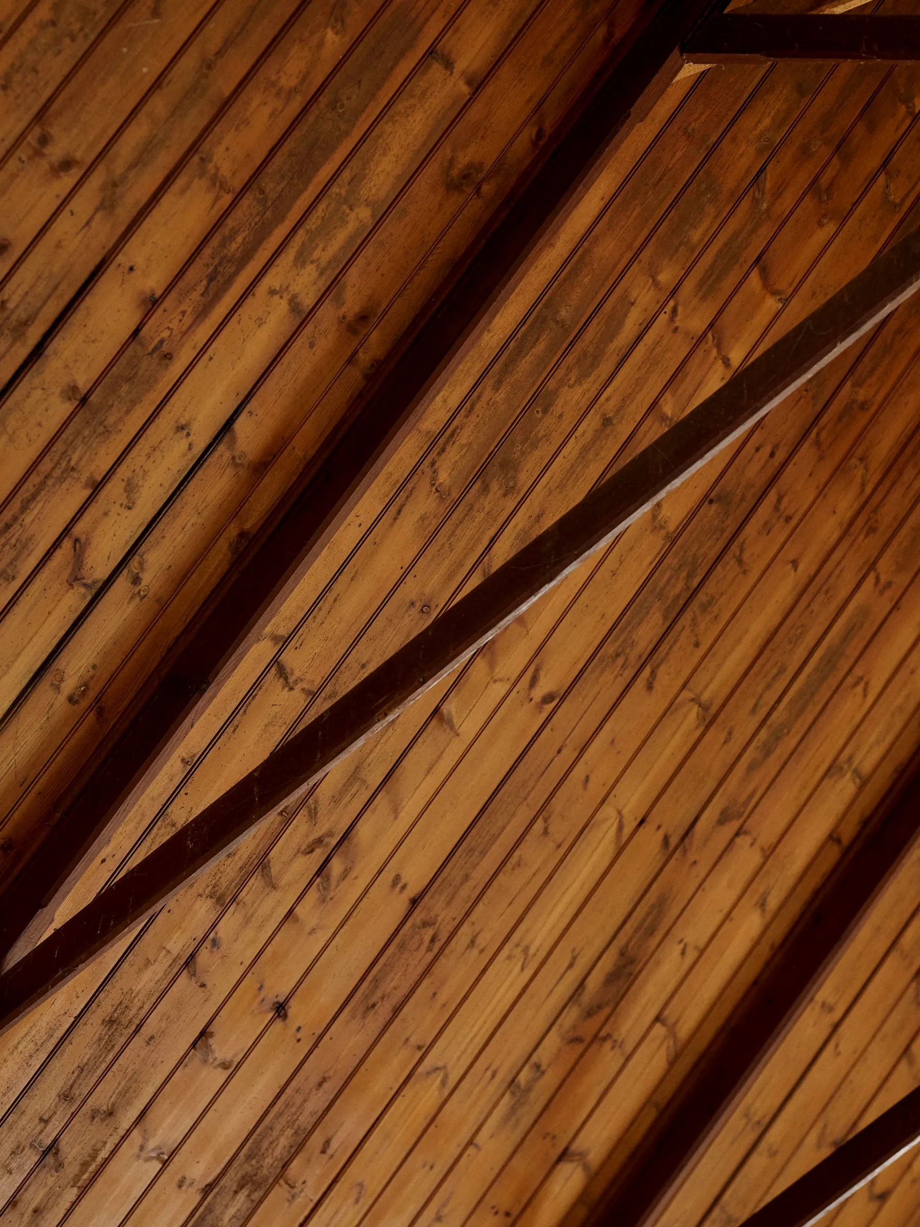Inside The Church: the lined timber ceiling and its dark beams